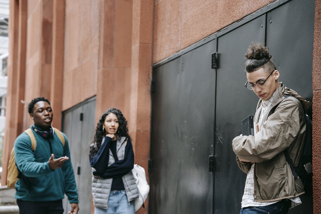 Group of diverse teenagers having a serious discussion in an urban outdoor setting.