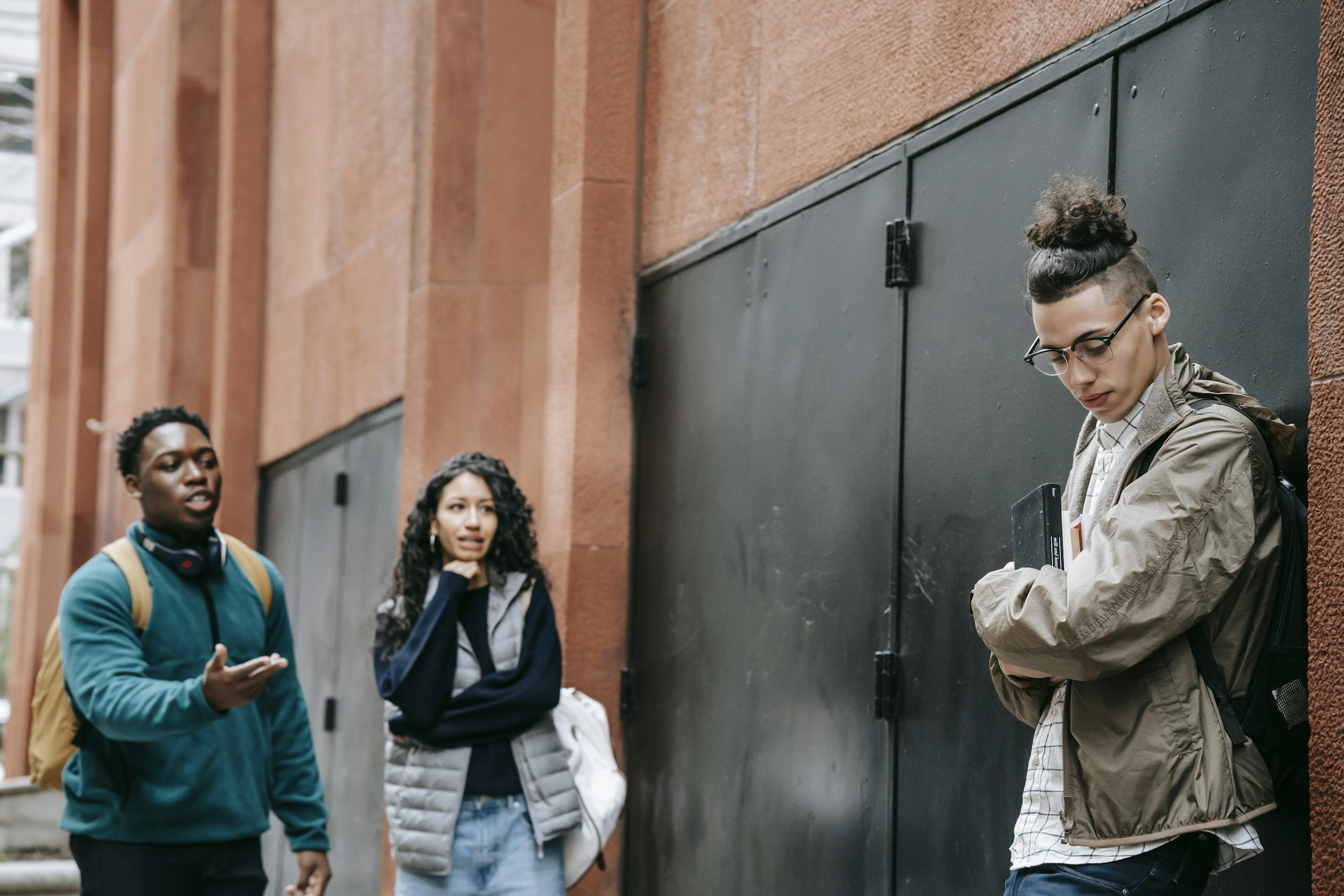 Group of diverse teenagers having a serious discussion in an urban outdoor setting.